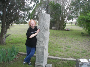 The distinctive Woodmen of the World tombstone of George M. Lock (1880-1912) is highlighted by HCHC's Linda Coker at Martin Church Cemetery.